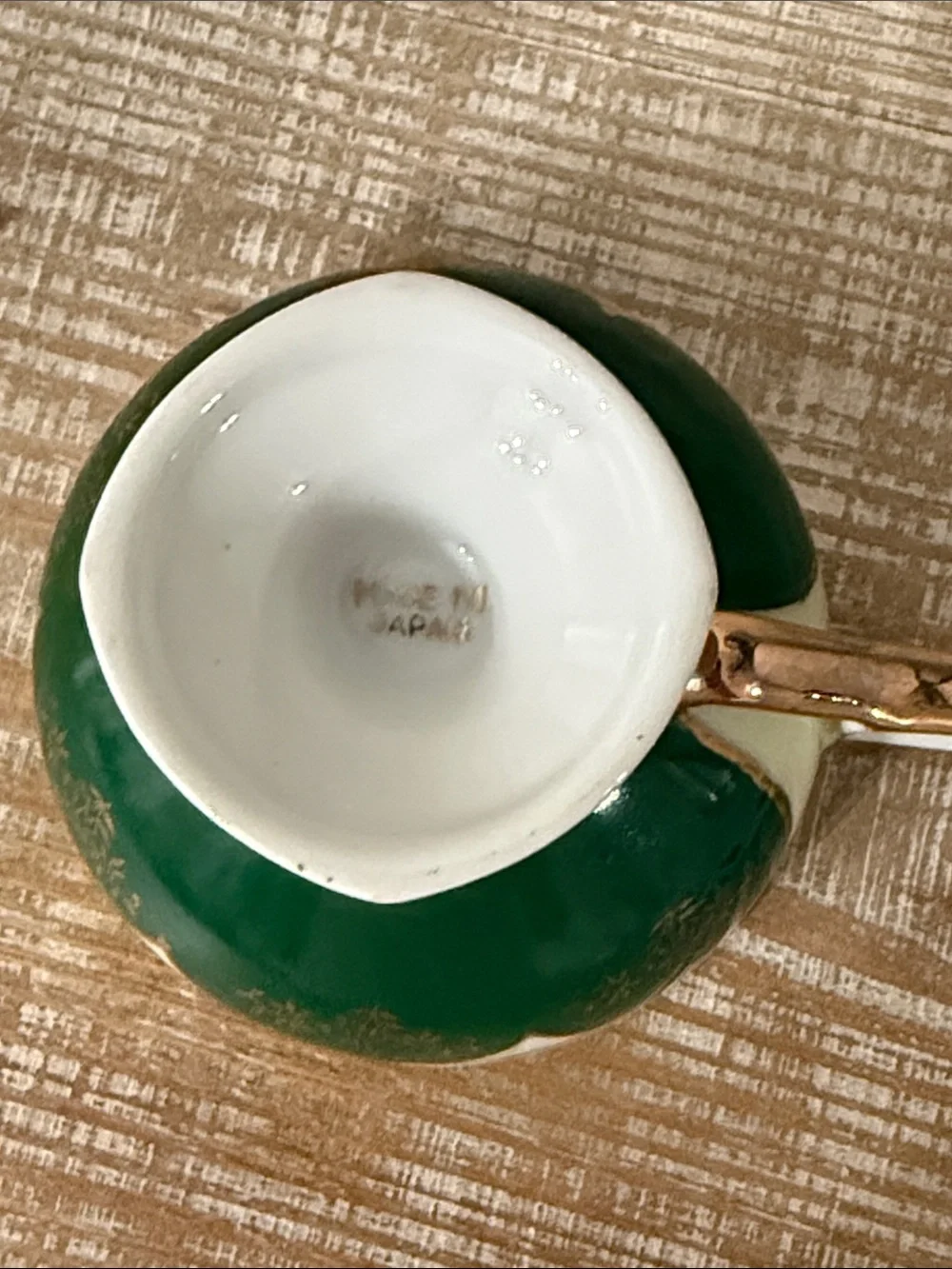 Vintage Japanese green and gold reticulated teacup, and pierced saucer.